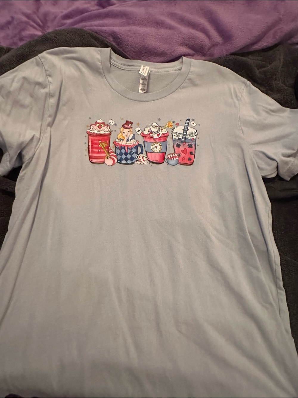 Women’s Light Blue Graphic T‑Shirt with Alice in Wonderland Drink Characters